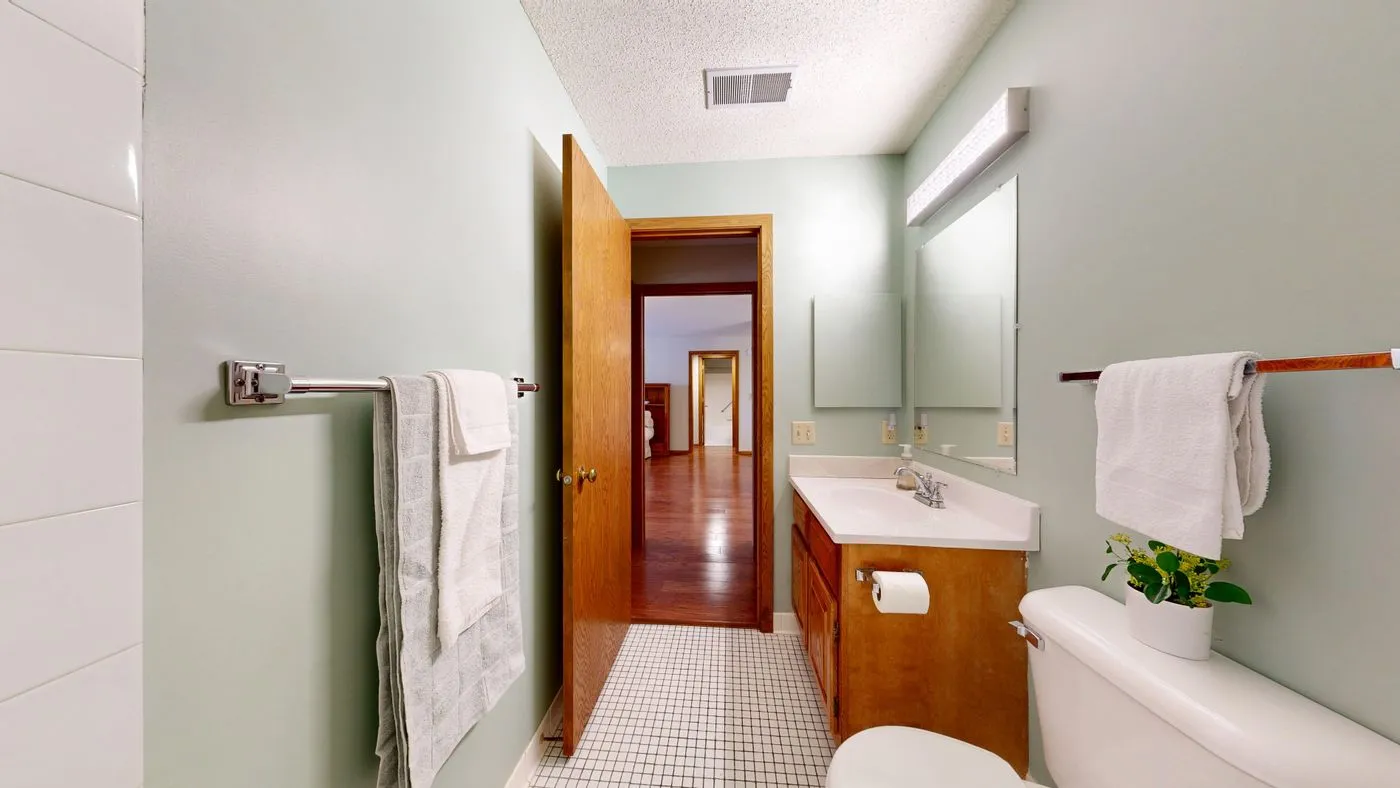 Bathroom with wooden cabinets and white towels
