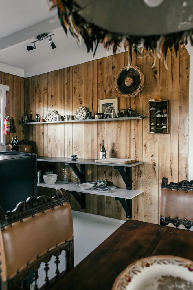 Rustic kitchen with wooden walls and a dining area
