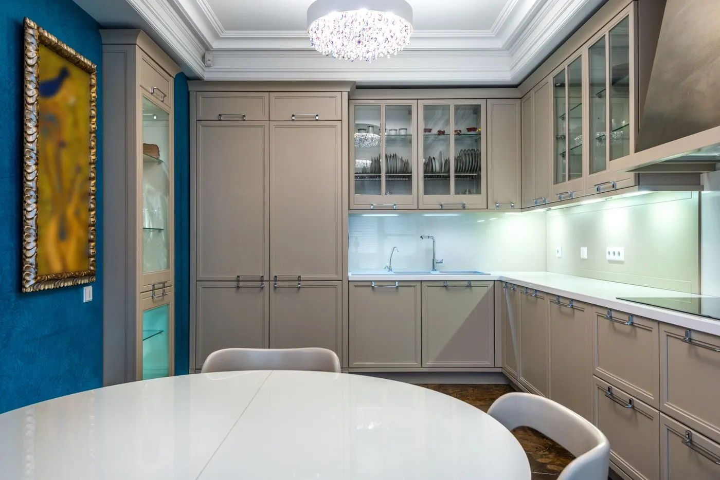 Kitchen cabinetry with a glass dining table