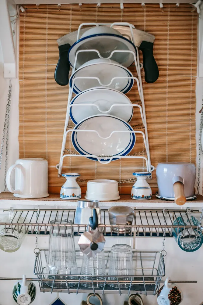 Dishes and mugs arranged on kitchen shelves