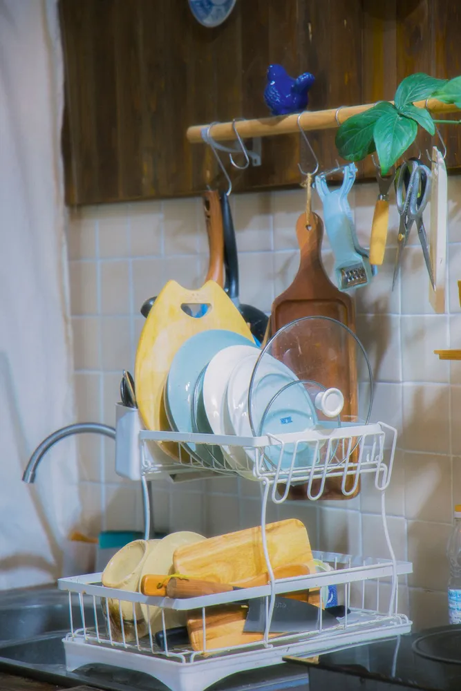 Kitchen dish rack beside cutting boards and accessories