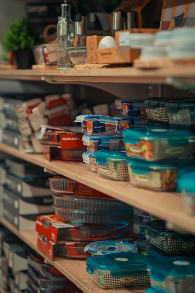 Storage containers arranged on kitchen pantry shelves