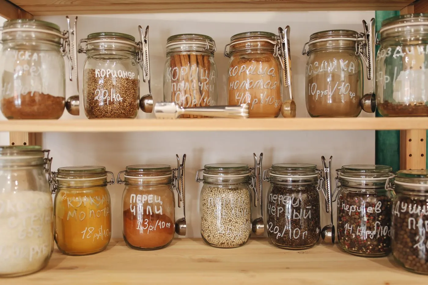 Glass jars of ingredients on wooden pantry shelves
